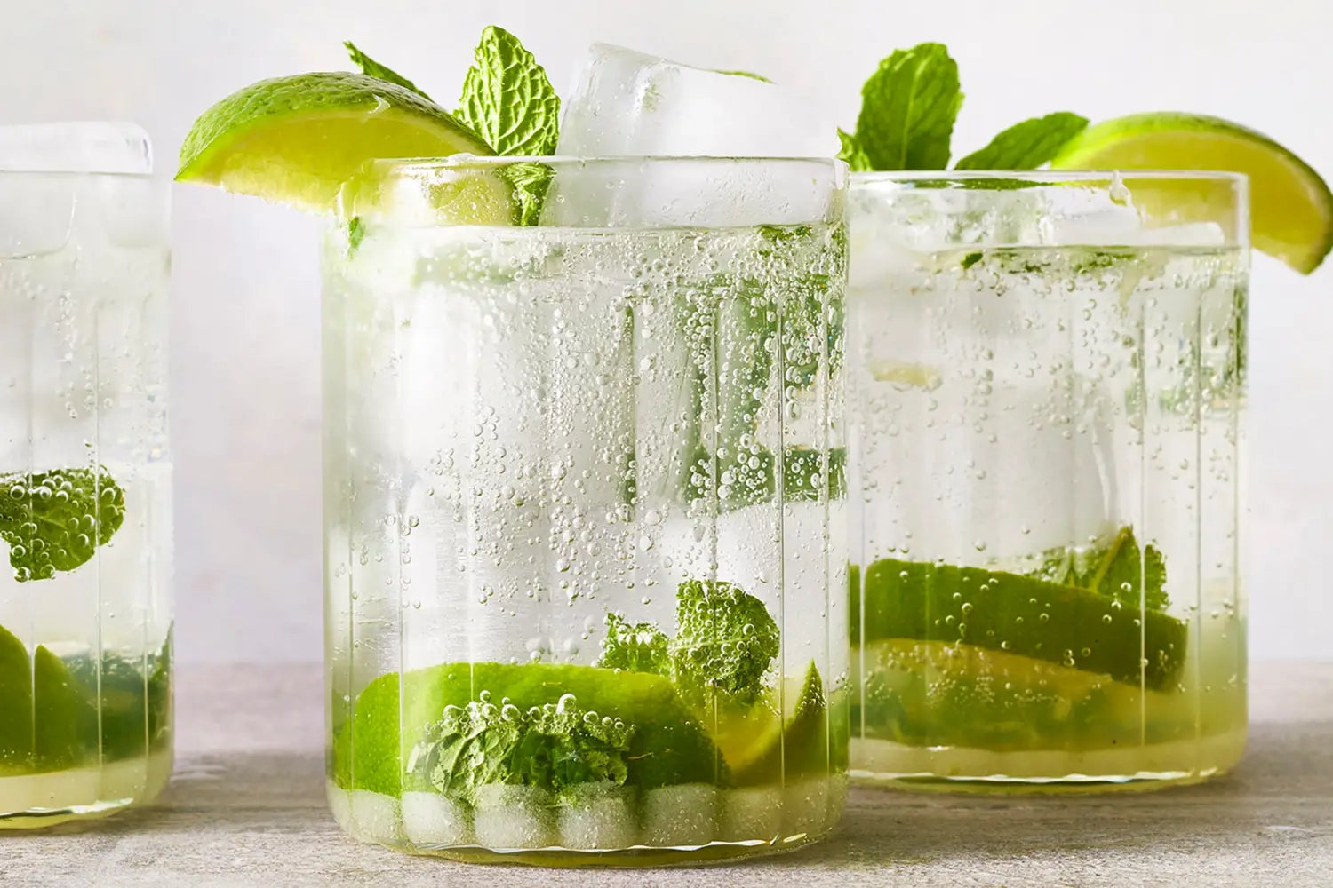 refreshing mojito drink in three glasses