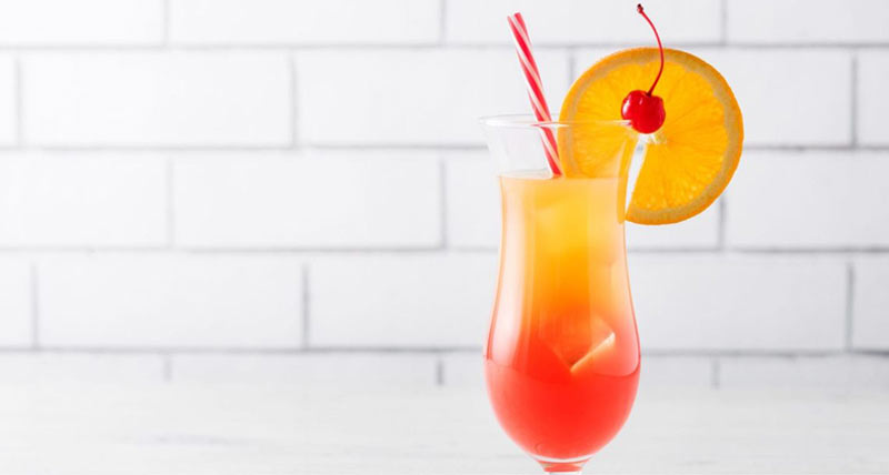 bright tequila sunrise with orange slice garnish